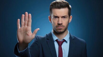 A man in a suit and tie making a stop sign. Suitable for business or traffic safety concepts