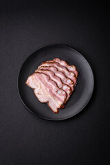 Delicious fresh pancetta or bacon with salt and spices cut into thin slices