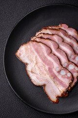 Delicious fresh pancetta or bacon with salt and spices cut into thin slices