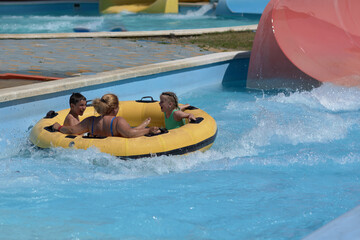 Group of People Riding on Raft in Pool