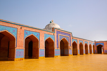 Fototapeta premium Shah Jahan Mosque in Thatta, Pakistan. Beautiful architecture, yellow, blue and orange colors. 