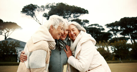 Fototapeta premium Talking, laughing and elderly woman friends outdoor in a park together for bonding during retirement. Happy, smile and funny with a group of senior people hugging in a garden for humor or fun