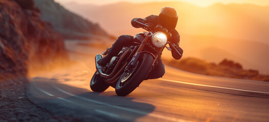 A motorcyclist travels fast on a road at sunset