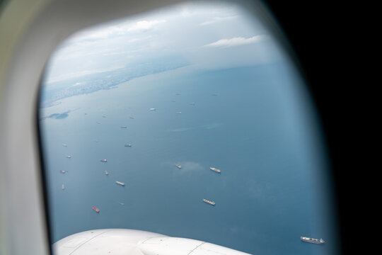 Looking down at large transportation boats from Commertial airplane window