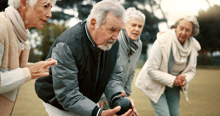 Senior man, game and senior people bowling in nature for retirement sports, teamwork and support. Bowling, friends and elderly man and woman in a group with a ball for a competition on a field togeth - Powered by Adobe