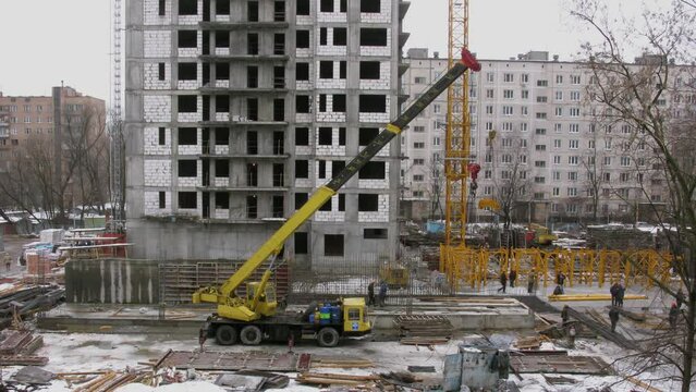 Worker use truck-crane on construction site of residential house