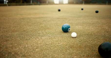 Green, balls and game of lawn bowling on grass, field or pitch in match or competition of outdoor...