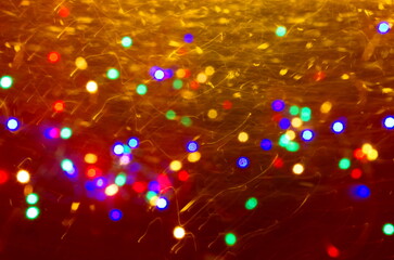 Colorful defocused bokeh lights blur sparkling red background Gold lights Golden sparks glowing...