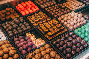 Assortment of fine chocolate candies, white, dark, and milk chocolate Sweets background.