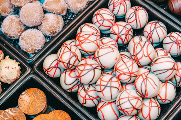 Assortment of fine chocolate candies, white, dark, and milk chocolate Sweets background.