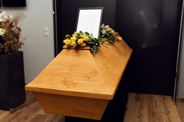 funeral concept. flowers on the coffin and an empty photo frame. overall plan. bereavement. death...