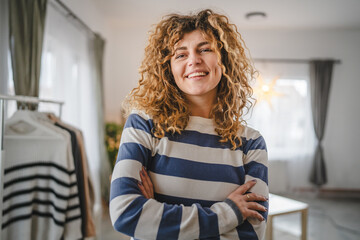 Portrait of adult caucasian woman with curly hair at home happy smile