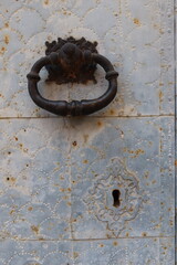 Busot, Alicante, Spain, January 28, 2024: Vertical view. Knocker and lock of the main door of the San Lorenzo Martir Church, 16th century. Busot, Alicante, Spain