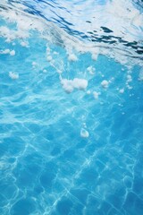 A picture of a blue pool with bubbles floating in it. Perfect for showcasing a refreshing and relaxing atmosphere.