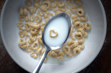 Top View of Heart Shaped Cereal and Milk in White Bowl