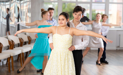 During rehearsal of reporting concert, adolescence boy and girl participants of dance workshop...