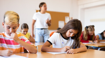 Schoolboy sitting at the desk in classroom at lesson in primary school