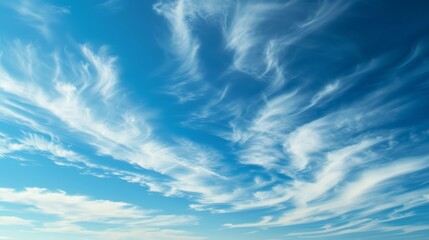 Obraz premium An expansive azure canvas dotted with fluffy cumulus clouds evokes a sense of tranquility and awe in the beauty of nature on a bright, sunny day