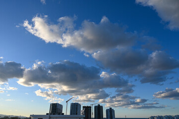 blue sky and clouds over the construction site of a residential complex 1