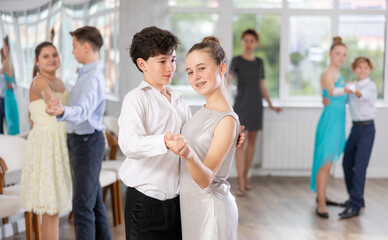 Fototapeta na wymiar Boy and girl dance couples ballroom dance waltz in studio