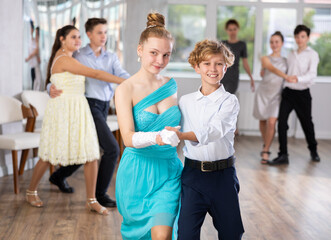 Boy and girl dance couples ballroom dance waltz in studio - obrazy, fototapety, plakaty