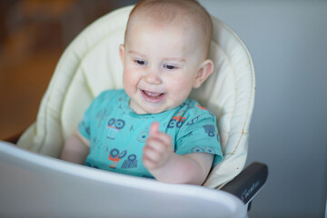 A baby is a happy baby in the first months of life, crawling around the house, smiling.