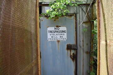 no trespassing rusty overgrown abandoned factory