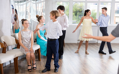 Boy invites girl to dance paired ballroom waltz dance in studio