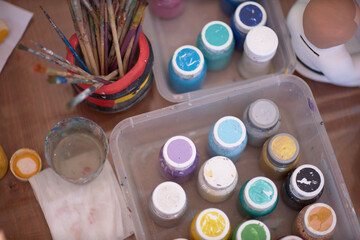 Paint brushes on the table, drawing creativity.
