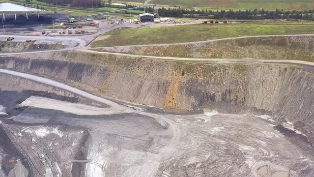 Layers of deep excavated open pit coal mine in Hunter Valley of Australia 4k.

