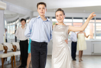 Happy girls paired with guys dance salsa in dance class