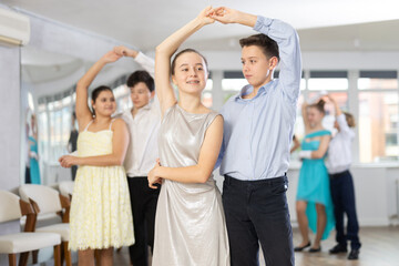 Couple boy and girl rehearsing waltz dance in studio