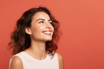Portrait of beautiful young happy smiling woman, over red background.