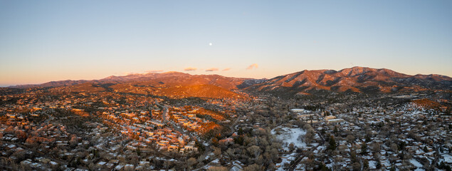 Sunset drone panorama above Santa Fe, New Mexico in the winter.
