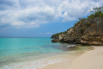 Fototapeta na wymiar Little Knip beach - paradise white sand beach with blue sky and clear azure water in Curacao, Netherlands Antilles, a Caribbean tropical Island.