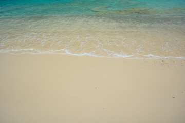Fototapeta na wymiar Beautiful blue ocean water with white foam edge. Space for text.