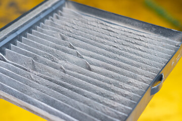 Closed up filthy car's air conditioning filter that needs to be replaced.