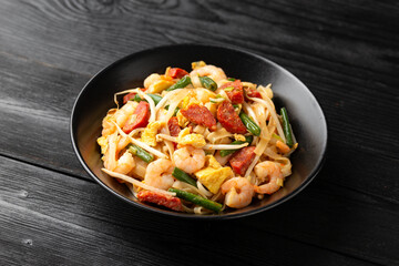 Char kway teow with rice noodles, prawn, sausages, egg and vegetables