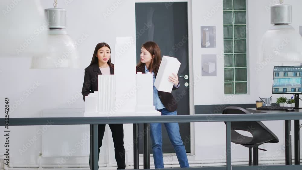Poster specialists examine 3d models to decide on measurements while developing small business growth ideas