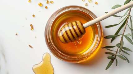 Honey pot and dipper isolated on white background
