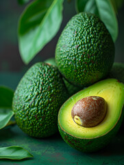 Halved Avocado with Stone on Green Background, Healthy Fat Source, Close-up"