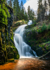 Fototapeta na wymiar Kamienczyk waterfall in the mountains, Szklarska Poreba, Poland