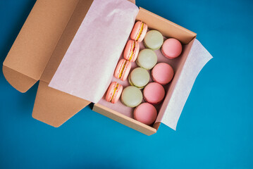 Close up colorful macarons dessert with vintage pastel tones in paper box