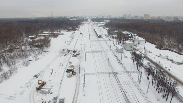 Snow-covered Moscow beltway railroad and cityscape on horizon