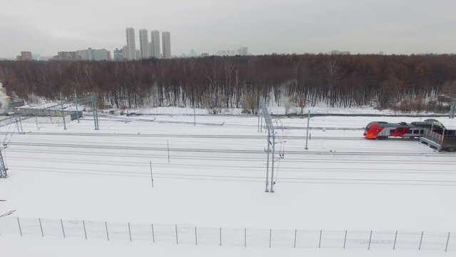 Dispatch of passengers train Lastochka at winter day. Aerial view