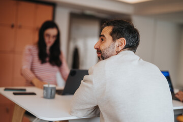 Contemporary home office setup with focused man and woman working.