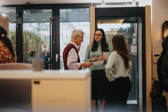 Diverse professionals engaging in conversation during a casual networking event in a modern office lobby, with a warm and welcoming ambiance.