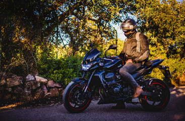 Man riding a black sport motorcycle