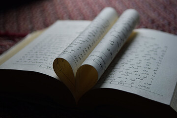 Heart shape made with an arabic book