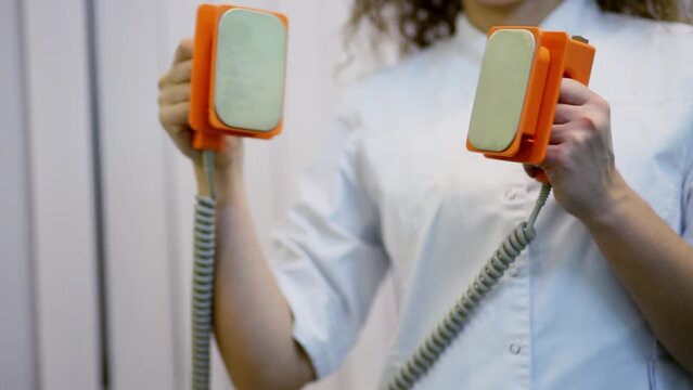 Doctor puts electroshock probes close together in hospital cabinet